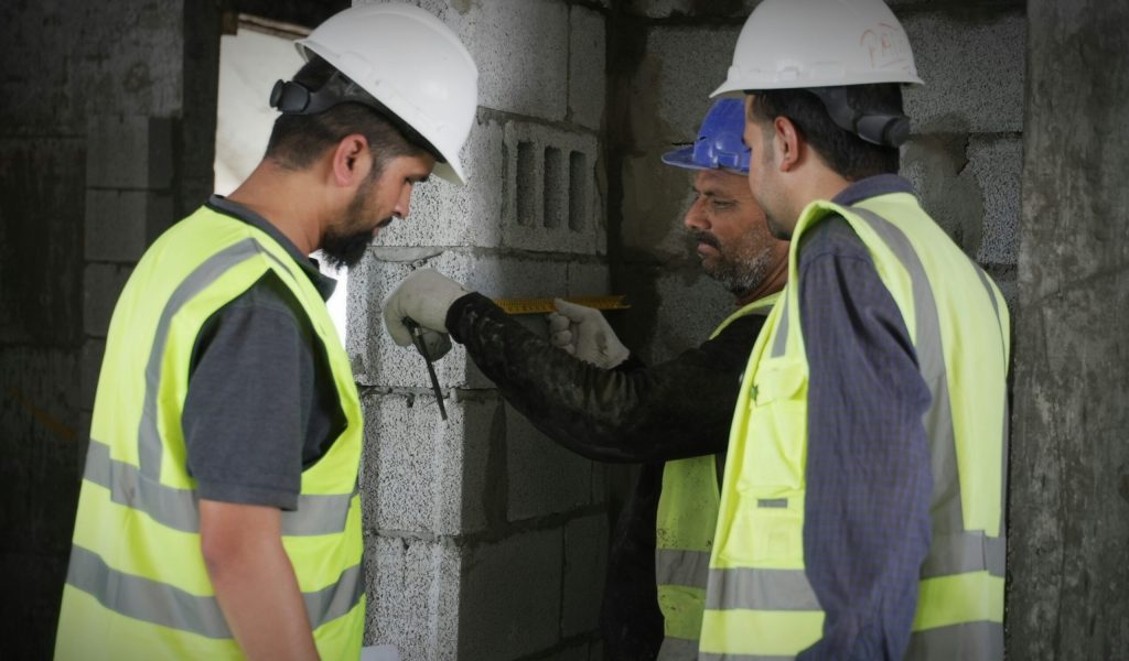 3 men in construction suits